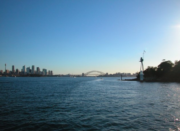 View of the City on the Harbour and Bradleys Head with the masthead of the HMAS Sydney.