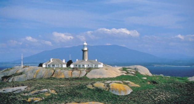 Granite lighthouse on Montague island with Mt Dromedary in the Background